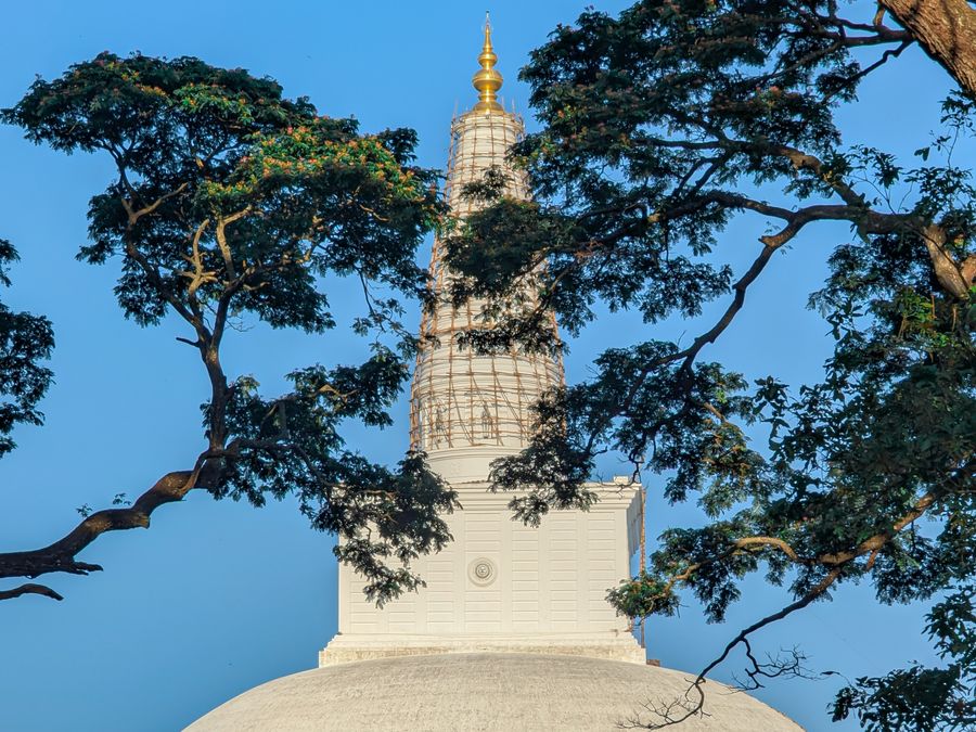 The white dome of a great stupa at Anuradhapura against a clear sky