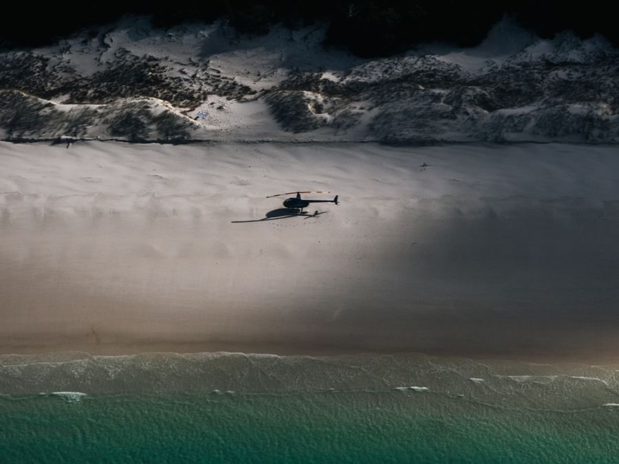 A helicopter in flight above the Sri Lankan coastline.