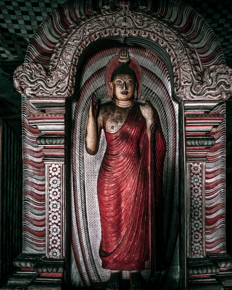 Ancient stone Buddha statue and ruins at a Sri Lankan heritage site